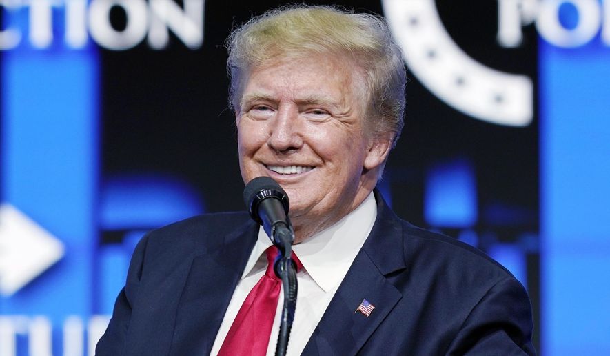 Former President Donald Trump smiles as he pauses while speaking to supporters at a Turning Point Action gathering in Phoenix, July 24, 2021.  Trump is slamming politicians who refuse to say whether they’ve received COVID-19 booster shots, calling them “gutless.” In an interview with One America News Network on Tuesday night, he said unnamed politicians have been afraid to admit they got the booster shot.  (AP Photo/Ross D. Franklin, File)