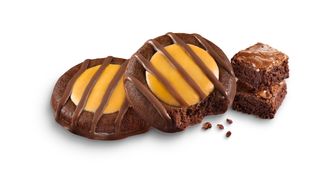 Pictured here, the new Adventurefuls cookie joins the nationwide lineup for the 2022 Girl Scout Cookie Season. Girl Scouts of the USA describes the new cookie as &quot;an indulgent brownie-inspired cookie with caramel-flavored crème and a hint of sea salt.&quot; (Image courtesy Girl Scouts of the USA)
