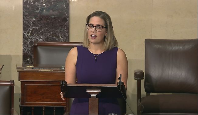 In this image from Senate Television, Sen. Kyrsten Sinema, D-Ariz., speaks on the floor of the U.S. Senate on Thursday, Jan. 13, 2022. President Joe Biden is set to meet privately with Senate Democrats at the Capitol, a visit intended to deliver a jolt to the party&#x27;s long-stalled voting and elections legislation. Before he arrived Sinema blunted the bill&#x27;s chances further, declaring she could not support a shortsighted rules change to get past a Republican blockade. (Senate Television via AP) ** FILE **