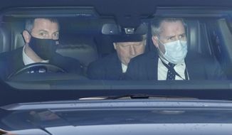 Britain&#39;s Prime Minister Boris Johnson, center, sits in a car as he leaves Parliament after attending the weekly Prime Ministers&#39; Questions session in London, Wednesday, Jan. 12, 2022. (AP Photo/Frank Augstein)