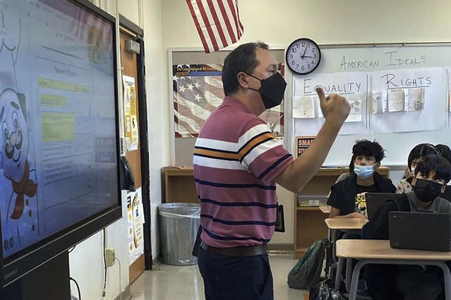 This photo shows Daniel Santos, a middle school history teacher during class, in Houston, in November, 2021. The superintendent of Boston schools is teaching classes. A school district outside of Dallas is holding a career fair in a cafeteria this weekend. And in New Mexico, the governor is calling in the National Guard. (Courtesy Daniel Santos via AP)
