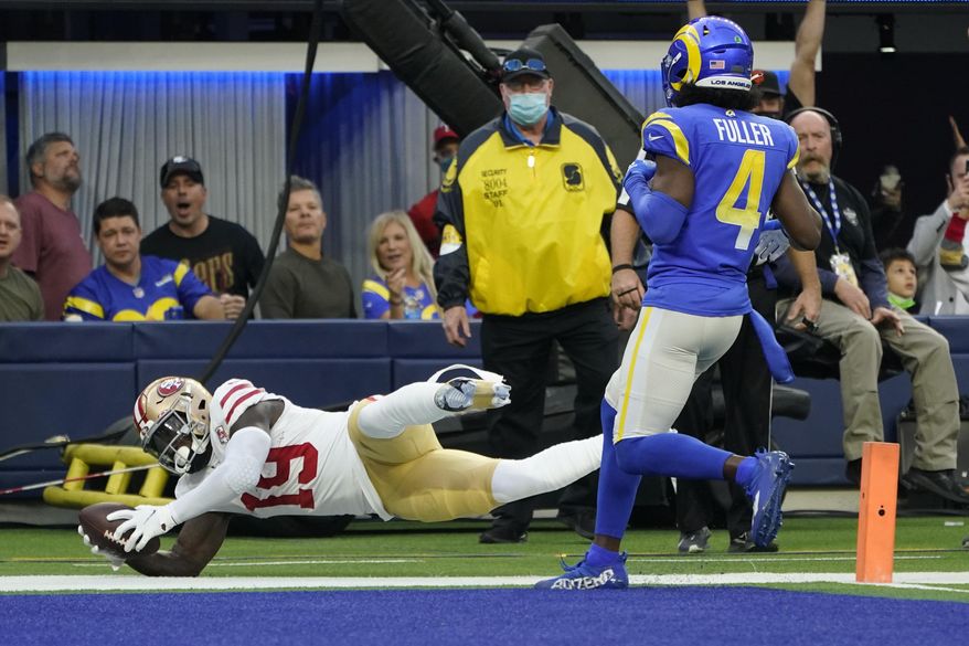 San Francisco 49ers wide receiver Deebo Samuel (19) scores a touchdown during the second half of an NFL football game against the Los Angeles Rams, Sunday, Jan. 9, 2022, in Inglewood, Calif. (AP Photo/Marcio Jose Sanchez)