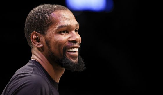 Brooklyn Nets forward Kevin Durant (7) smiles during warmups before an NBA basketball game against the Oklahoma City Thunder, Thursday, Jan. 13, 2022, in New York. (AP Photo/Jessie Alcheh)