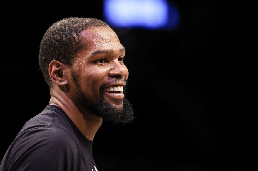 Brooklyn Nets forward Kevin Durant (7) smiles during warmups before an NBA basketball game against the Oklahoma City Thunder, Thursday, Jan. 13, 2022, in New York. (AP Photo/Jessie Alcheh)