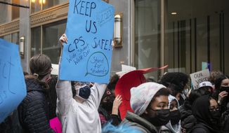 Chicago Public Schools students protest outside the Chicago Public Schools headquarters during a district-wide walkout to demand Mayor Lori Lightfoot, Chicago Department of Public Health Dr. Allison Arwady and Chicago Public Schools CEO Pedro Martinez to include them in the conversation about COVID-19 safety in schools, Friday afternoon, Jan. 14, 2022, in Chicago. Many students advocated for remote learning and stood with the Chicago Teachers Union which has been pushing for improved COVID-19 safety protocols in schools. (Pat Nabong/Chicago Sun-Times via AP)
