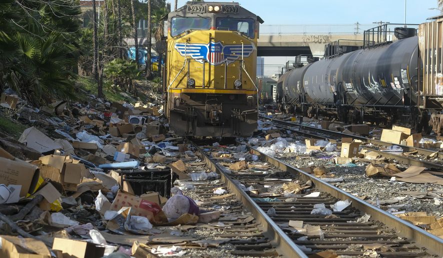Shredded boxes and packages are seen at a section of the Union Pacific train tracks in downtown Los Angeles Friday, Jan. 14, 2022.  Thieves have been raiding cargo containers aboard trains nearing downtown Los Angeles for months, leaving the tracks blanketed with discarded packages. The sea of debris left behind included items that the thieves apparently didn&#39;t think were valuable enough to take, CBSLA reported Thursday. (AP Photo/Ringo H.W. Chiu)