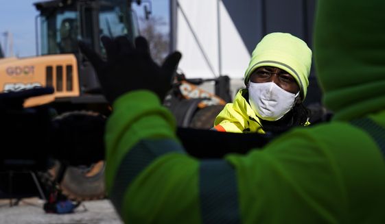 A Georgia Department of Transportation response member looks at a brine truck tank being filled ahead of a winter storm at the GDOT&#39;s Maintenance Activities Unit location on Friday, Jan. 14, 2022, in Forest Park, Ga. A winter storm is headed south that could effect much of Georgia through Sunday. (AP Photo/Brynn Anderson)