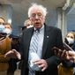 Sen. Bernie Sanders, I-Vt., makes comments to reporters about Sen. Joe Manchin, D-W.Va., as he walks to the Senate Chamber for a vote, on Dec. 15, 2021, in Washington. Just over a year ago, millions of energized young people, women, voters of color and independents joined forces to send Joe Biden to the White House. But 12 months after he entered the Oval Office, many describe a coalition in crisis.(AP Photo/Jacquelyn Martin, File)