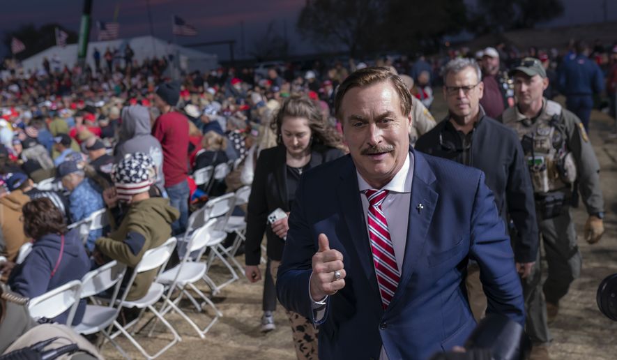 Mike Lindell, CEO of MyPillow, walks past a crowd of supporters during a rally for former President Donald Trump on Saturday, Jan. 15, 2022, in Florence, Az. (AP Photo/Nathan Howard)
