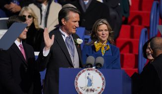 Gov. Glenn Youngkin, with wife Suzanne Youngkin takes the oath of office during an inauguration ceremony, Saturday, Jan. 15, 2022, in Richmond, Va. (AP Photo/Julio Cortez)