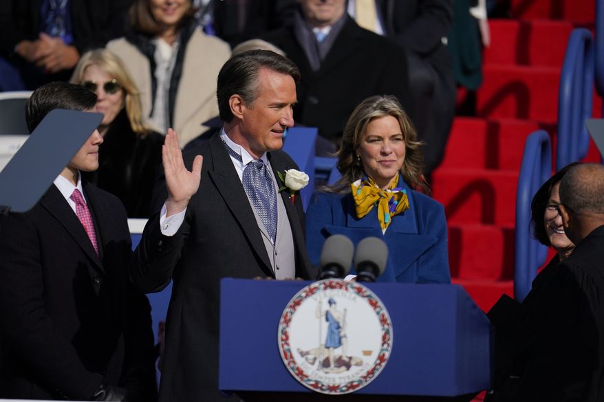 Gov. Glenn Youngkin, with wife Suzanne Youngkin takes the oath of office during an inauguration ceremony, Saturday, Jan. 15, 2022, in Richmond, Va. (AP Photo/Julio Cortez)
