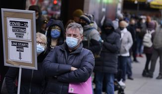 People wait in line at a COVID-19 testing site in this file photo from Times Square, New York, Monday, Dec. 13, 2021. Scientists are warning that omicron’s lightning-fast spread across the globe practically ensures it won’t be the last worrisome coronavirus variant. And there’s no guarantee the next ones will cause milder illness or that vaccines will work against them. (AP Photo/Seth Wenig, File)  **FILE**
