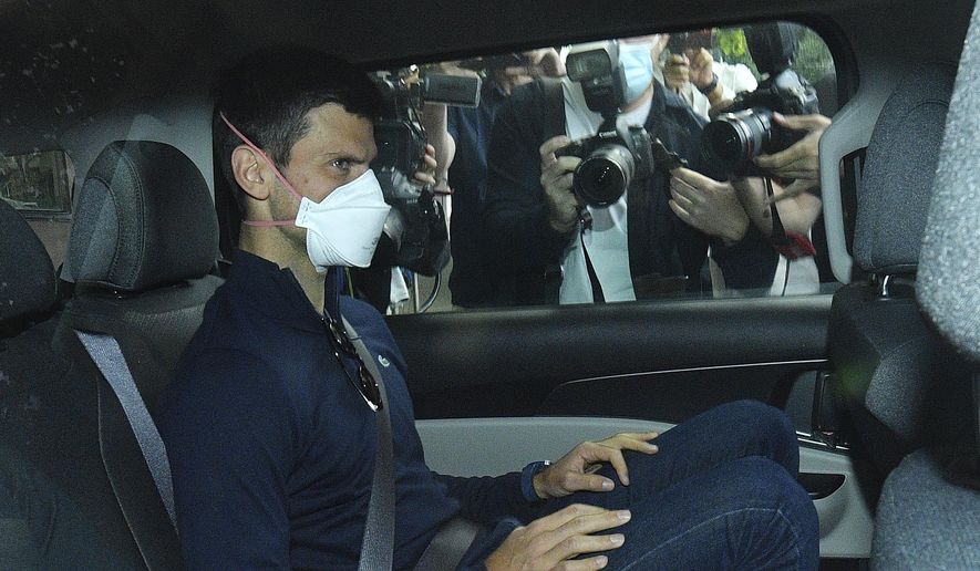 Serbian tennis player Novak Djokovic rides in car as he leaves a government detention facility before attending a court hearing at his lawyers office in Melbourne, Australia, Sunday, Jan. 16, 2022. A federal court hearing has been scheduled for Sunday, a day before the men&#39;s No. 1-ranked tennis player and nine-time Australian Open champion was due to begin his title defense at the first Grand Slam tennis tournament of the year. (James Ross/AAP via AP)