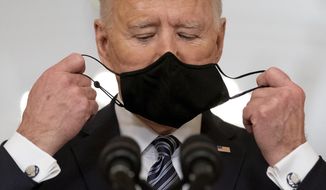 FILE - President Joe Biden takes off his mask to speak about the COVID-19 pandemic during a prime-time address from the East Room of the White House, on March 11, 2021, in Washington. (AP Photo/Andrew Harnik, File)