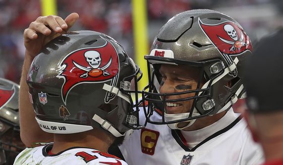 Tampa Bay Buccaneers quarterback Tom Brady, right, celebrates with wide receiver Mike Evans after Evans caught a touchdown pass against the Philadelphia Eagles during the second half of an NFL wild-card football game Sunday, Jan. 16, 2022, in Tampa, Fla. (AP Photo/Mark LoMoglio) **FILE**