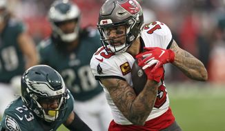 Tampa Bay Buccaneers wide receiver Mike Evans (13) pulls in a reception in front of Philadelphia Eagles safety Rodney McLeod (23) during the second half of an NFL wild-card football game Sunday, Jan. 16, 2022, in Tampa, Fla. (AP Photo/Mark LoMoglio)