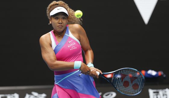 Naomi Osaka of Japan plays a backhand return to Camila Osorio of Colombia during their first round match at the Australian Open tennis championships in Melbourne, Australia, Monday, Jan. 17, 2022. (AP Photo/Hamish Blair)