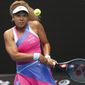 Naomi Osaka of Japan plays a backhand return to Camila Osorio of Colombia during their first round match at the Australian Open tennis championships in Melbourne, Australia, Monday, Jan. 17, 2022. (AP Photo/Hamish Blair)