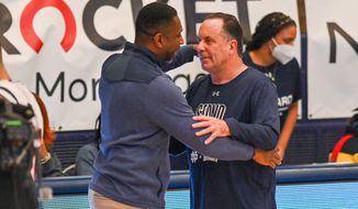 Notre Dame coach Mike Brey and Howard coach Kenneth Blakeney embrace after the NCAA men&#39;s basketball game at Burr Gymnasium on Monday, Jan. 17, 2022 in Washington, DC. (All Pro Reels)