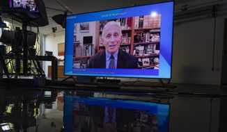 A screen shows Dr. Anthony Fauci, director of the National Institute of Allergy and Infectious Diseases (NIAID), during a remote panel titled &quot;COVID 19: What&#x27;s Next?&quot; at the Davos Agenda 2022, in Cologny near Geneva, Switzerland, Monday, Jan. 17, 2022. (Salvatore Di Nolfi/Keystone via AP) ** FILE **