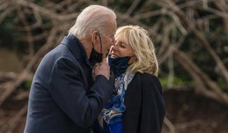 President Joe Biden kisses first lady Jill Biden before boarding Marine One to visit wounded troops at Walter Reed National Military Medical Center, on the South Lawn of the White House, on Jan. 29, 2021, in Washington. (AP Photo/Evan Vucci, File)