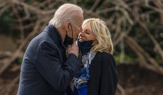 President Joe Biden kisses first lady Jill Biden before boarding Marine One to visit wounded troops at Walter Reed National Military Medical Center, on the South Lawn of the White House, on Jan. 29, 2021, in Washington. (AP Photo/Evan Vucci, File)