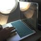 A passenger uses a laptop aboard a commercial airline flight from Boston to Atlanta on July 1, 2017. The airline industry is raising the stakes in a showdown with AT&amp;T and Verizon over the telecom companies plan to launch new 5G wireless service this week, warning that thousands of flights could be grounded or delayed if the rollout takes place near major airports. CEOs of the nation&#39;s largest airlines said Monday, Jan. 18, 2022, that interference from the wireless service on a key instrument on planes is worse than they originally thought. (AP Photo/Bill Sikes) **FILE**