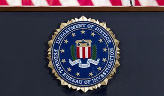 This June 14, 2018, file photo shows an FBI seal on a podium before a news conference at the agency&#x27;s headquarters in Washington. The FBI and other federal government agencies are increasingly looking to counter cyberthreats through tools other than criminal indictments. That&#x27;s according to the bureau’s top cyber official. (AP Photo/Jose Luis Magana, File)