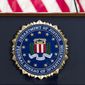 This June 14, 2018, file photo shows an FBI seal on a podium before a news conference at the agency&#39;s headquarters in Washington. The FBI and other federal government agencies are increasingly looking to counter cyberthreats through tools other than criminal indictments. That&#39;s according to the bureau’s top cyber official. (AP Photo/Jose Luis Magana, File)