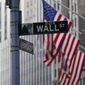 The Wall St. street sign is framed by the American flags flying outside the New York Stock exchange, Friday, Jan. 14, 2022, in the Financial District.  (AP Photo/Mary Altaffer) **FILE**