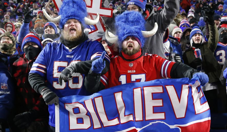 Buffalo Bills fans celebrate during the second half of an NFL wild-card playoff football game against the New England Patriots in Orchard Park, N.Y., Saturday, Jan. 15, 2022. (AP Photo/ Jeffrey T. Barnes)