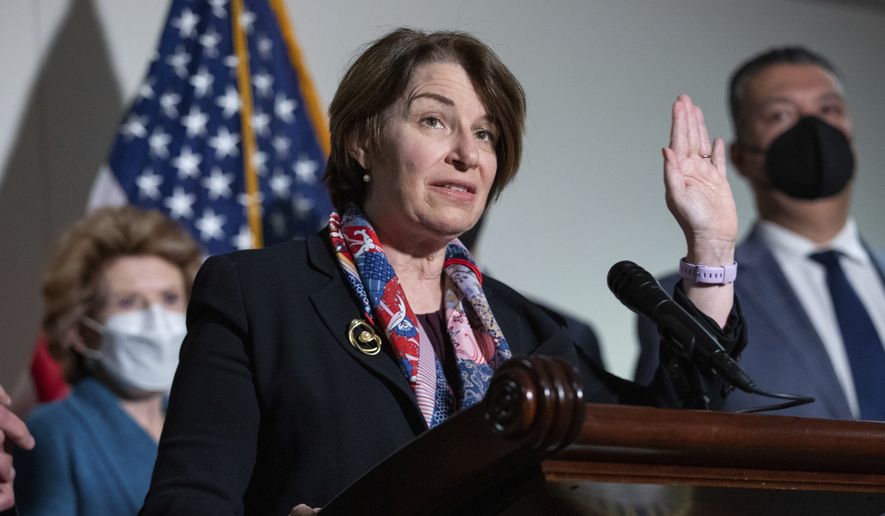 Sen. Amy Klobuchar, D-Minn., responds to questions from reporters alongside, from left, Sen. Debbie Stabenow, D-Mich., and Sen. Alex Padilla, D-Calif., during a press conference regarding the Democratic party's shift to focus on voting rights at the Capitol in Washington, Tuesday, Jan. 18, 2022. (AP Photo/Amanda Andrade-Rhoades)