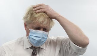 Britain&#39;s Prime Minister Boris Johnson gestures during a visit to Finchley Memorial Hospital, in North London, Tuesday, Jan. 18, 2022. (Ian Vogler, Pool Photo via AP)