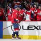 Washington Capitals left wing Alex Ovechkin (8) celebrates his goal with teammates in the first period of an NHL hockey game against the Winnipeg Jets, Tuesday, Jan. 18, 2022, in Washington. (AP Photo/Patrick Semansky)