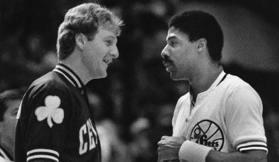 Boston Celtics team captain Larry Bird, left, and Philadelphia 76ers team captain Julius Erving shake hands before the start of their NBA game in Philadelphia, Dec. 13, 1984. (AP Photo/Peter Morgan, File) **FILE**