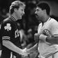Boston Celtics team captain Larry Bird, left, and Philadelphia 76ers team captain Julius Erving shake hands before the start of their NBA game in Philadelphia, Dec. 13, 1984. (AP Photo/Peter Morgan, File) **FILE**