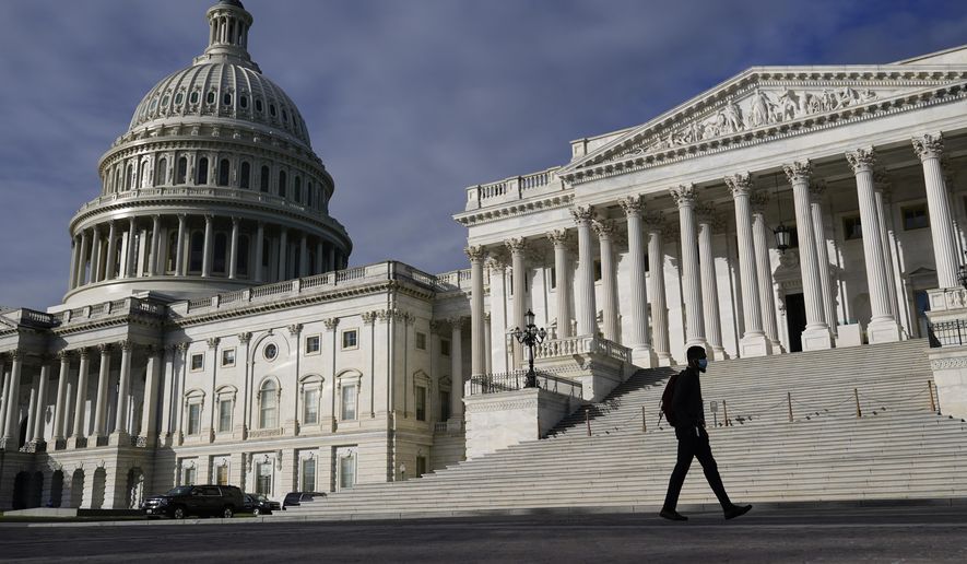 A man walks past the U.S. Capitol on Oct. 27, 2021, on Capitol Hill in Washington. (AP Photo/Patrick Semansky, File)