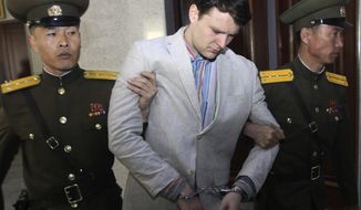 In this March 16, 2016, file photo, American student Otto Warmbier, center, is escorted at the Supreme Court in Pyongyang, North Korea. The parents of Otto Warmbier, the U.S. student who died after being taken hostage by North Korea and released by the country in a coma in 2017, should receive $240,300 seized from a North Korean bank account, a federal judge ruled last week. (AP Photo/Jon Chol Jin, File)