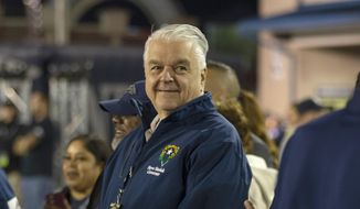 Nevada Gov. Steve Sisolak stands on the sidelines before a NCAA college football game in Reno, Nev., on Oct. 29, 2021. (AP Photo/Tom R. Smedes, File)