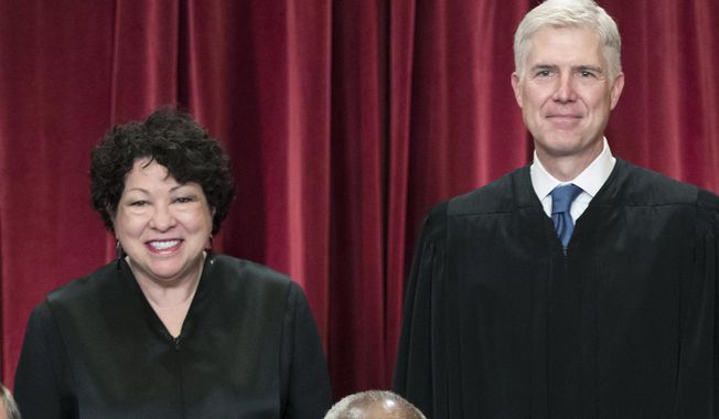 Associate Justice Sonia Sotomayor, left, and Associate Justice Neil Gorsuch, gather with other justices of the U.S. Supreme Court for an official group portrait, June 1, 2017, at the Supreme Court Building in Washington. Both justices deny an earlier media report that they were at odds over the wearing of masks in court during the recent surge in coronavirus cases. (AP Photo/J. Scott Applewhite, File)  **FILE**