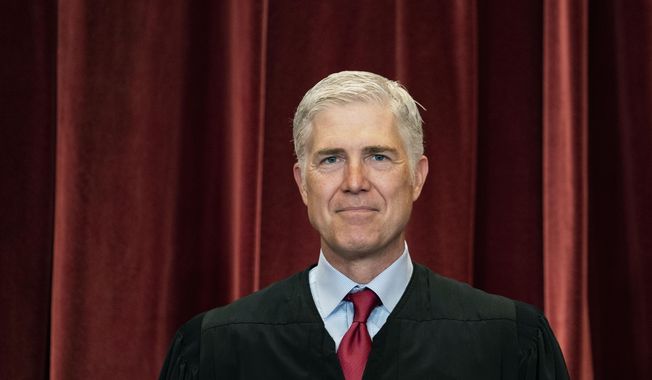 Associate Justice Neil Gorsuch stands during a group photo at the Supreme Court in Washington, April 23, 2021. (Erin Schaff/The New York Times via AP, Pool) **FILE**