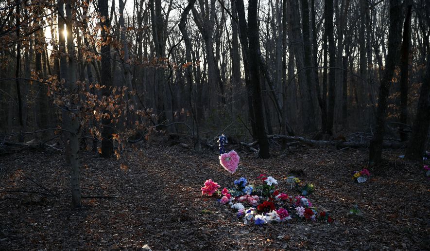 Flowers adorn Anton Black's gravesite in the corner of a cemetery, Jan. 28, 2019, in Kent County, Md. A federal judge on Tuesday, Jan. 19, 2022, has refused to throw out a lawsuit’s claims that police on Maryland’s Eastern Shore used excessive force on Anton Black, a 19-year-old Black man who died in 2018 during a struggle with officers who handcuffed him and shackled his legs. (AP Photo/Patrick Semansky, File)