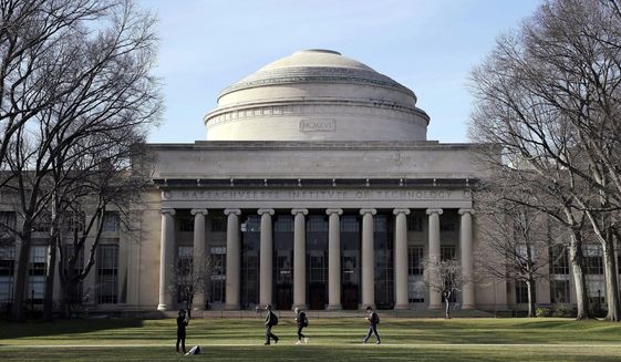FILE - Students walk past the &quot;Great Dome&quot; atop Building 10 on the Massachusetts Institute of Technology campus, April 3, 2017, in Cambridge, Mass. The Justice Department dropped its case Thursday, Jan. 20, 2022 against MIT professor Gang Chen, charged last year with hiding work he did for the Chinese government, saying it &quot;could no longer meet its burden of proof at trial.&quot; Chen was accused last year of concealing ties to Beijing while also collecting U.S. dollars for his nanotechnology research. (AP Photo/Charles Krupa, File)