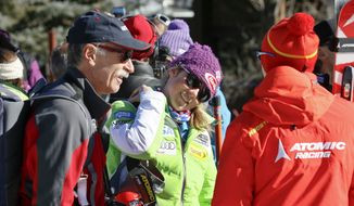 Mikaela Shiffrin, center, talks with her ski technician, right, along with her father, Jeff Shiffrin, left, after a practice run for the women&#x27;s World Cup ski race in Aspen, Colo., Nov. 23, 2012. Jeff Shiffrin died at age 65 on Feb. 2, 2020, in an accident at the family home in Colorado, (AP Photo/Nathan Bilow, File) **FILE**