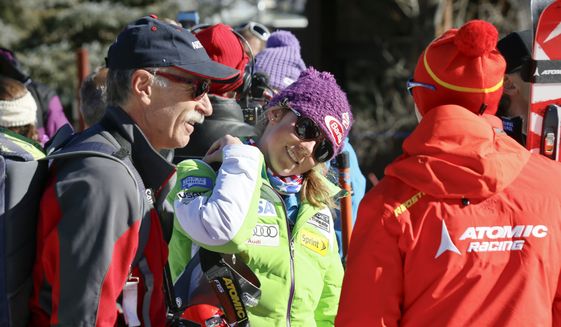 Mikaela Shiffrin, center, talks with her ski technician, right, along with her father, Jeff Shiffrin, left, after a practice run for the women&#39;s World Cup ski race in Aspen, Colo., Nov. 23, 2012. Jeff Shiffrin died at age 65 on Feb. 2, 2020, in an accident at the family home in Colorado, (AP Photo/Nathan Bilow, File) **FILE**