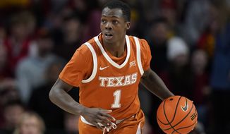 Texas guard Andrew Jones (1) drives up court during an NCAA college basketball game against Iowa State, Saturday, Jan. 15, 2022, in Ames, Iowa. (AP Photo/Charlie Neibergall)