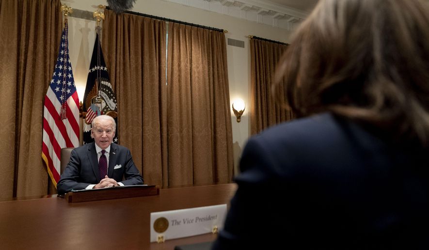 President Joe Biden, accompanied by Vice President Kamala Harris, right, speaks as he meets with members of the Infrastructure Implementation Task Force to discuss the Bipartisan Infrastructure Law, in the Cabinet Room at the White House in Washington, Thursday, Jan. 20, 2022. (AP Photo/Andrew Harnik)