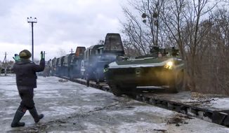 In this photo taken from video provided by the Russian Defense Ministry Press Service, A Russian armored vehicle drives off a railway platform after arrival in Belarus, Wednesday, Jan. 19, 2022. In a move that further beefs up forces near Ukraine, Russia has sent an unspecified number of troops from the country&#39;s far east to its ally Belarus, which shares a border with Ukraine, for major war games next month. (Russian Defense Ministry Press Service via AP)