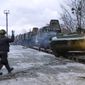 In this photo taken from video provided by the Russian Defense Ministry Press Service, A Russian armored vehicle drives off a railway platform after arrival in Belarus, Wednesday, Jan. 19, 2022. In a move that further beefs up forces near Ukraine, Russia has sent an unspecified number of troops from the country&#39;s far east to its ally Belarus, which shares a border with Ukraine, for major war games next month. (Russian Defense Ministry Press Service via AP)
