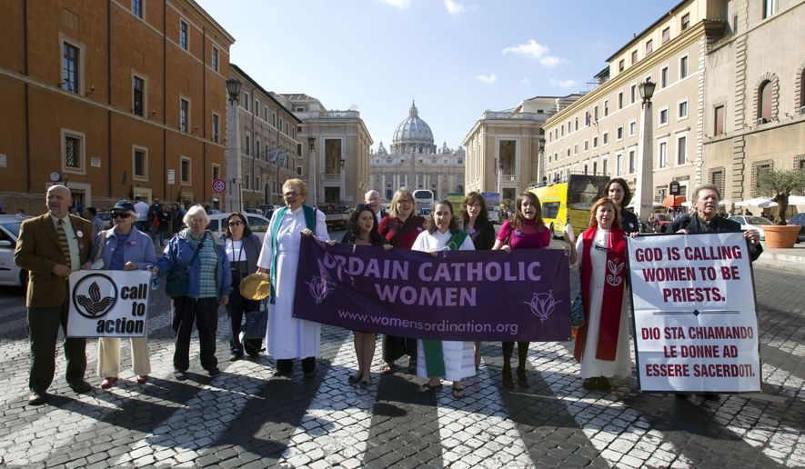 Members of the Women&#39;s Ordination Conference group stage a protest in front of St. Peter&#39;s Basilica, in Rome, on Oct. 17, 2011. The Vatican has included a group that advocates for women’s ordination on a website promoting its two-year consultation of rank-and-file Catholics in the latest sign that Pope Francis wants to hear from all Catholics during the process. The Women’s Ordination Conference has launched a “Let Her Voice Carry” campaign in conjunction with the Vatican’s 2023 “synod” or gathering of the world’s bishops. In the run-up to the meeting, the Vatican has asked dioceses, religious orders and other Catholic groups to embark on listening sessions to hear from ordinary Catholics about their needs. (AP Photo/Andrew Medichini, File)